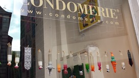 The right Condomerie window features colorful and whimsical condoms.