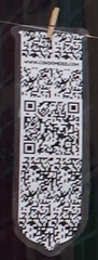 A condom with a QR code on it. A condom with a QR code on it.